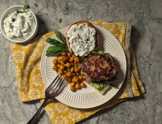 Overhead shot of plated Mediterranean turkey burger with roasted chickpeas