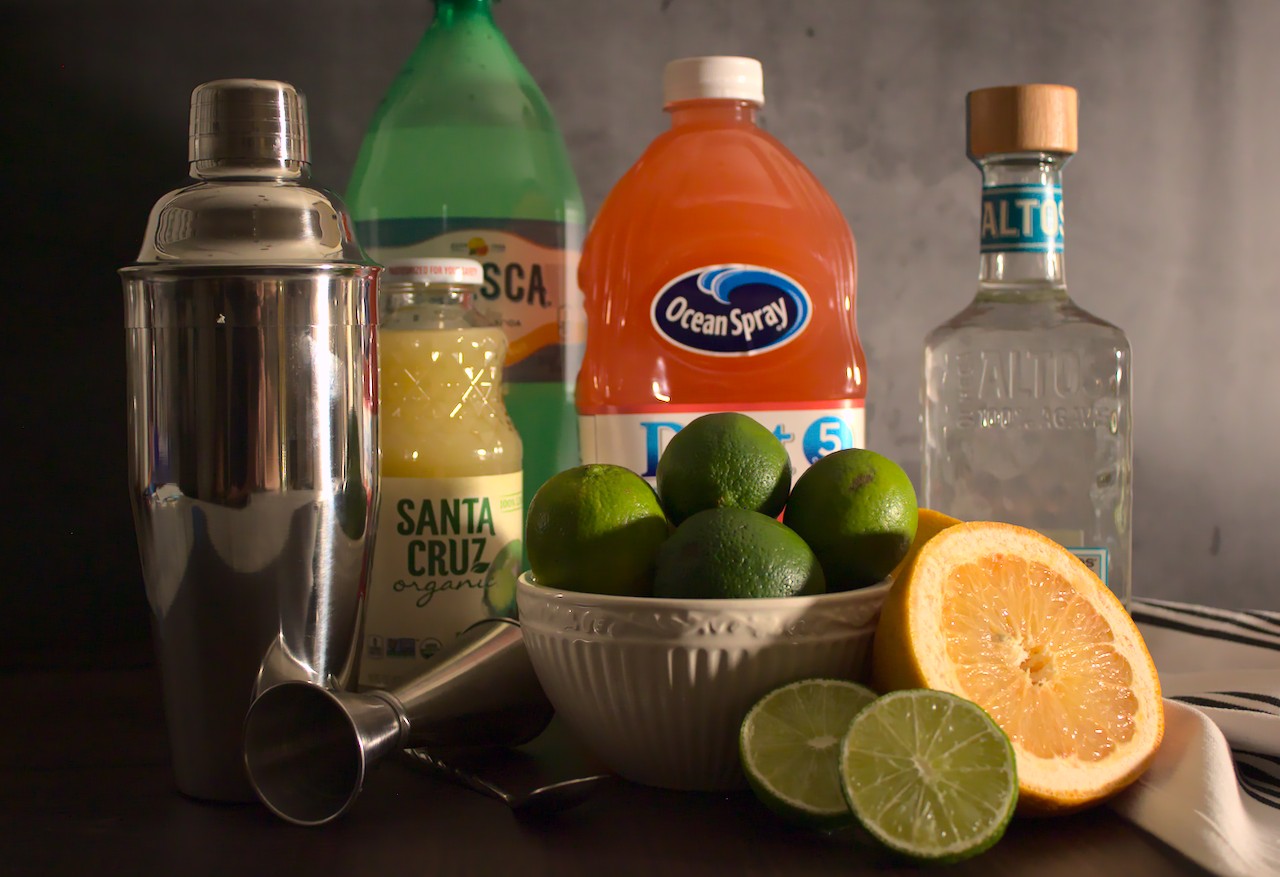 Photo of limes, grapefruit, grapefruit juice, lime juice, tequila, and fresca next to a cocktail shaker