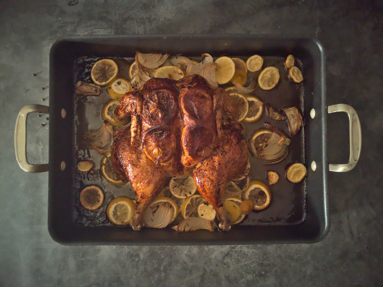 Overhead shot of roasted spatchcocked chicken in a roasting pan