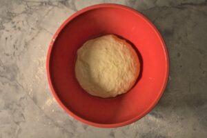 Pizza dough in a bowl before rising