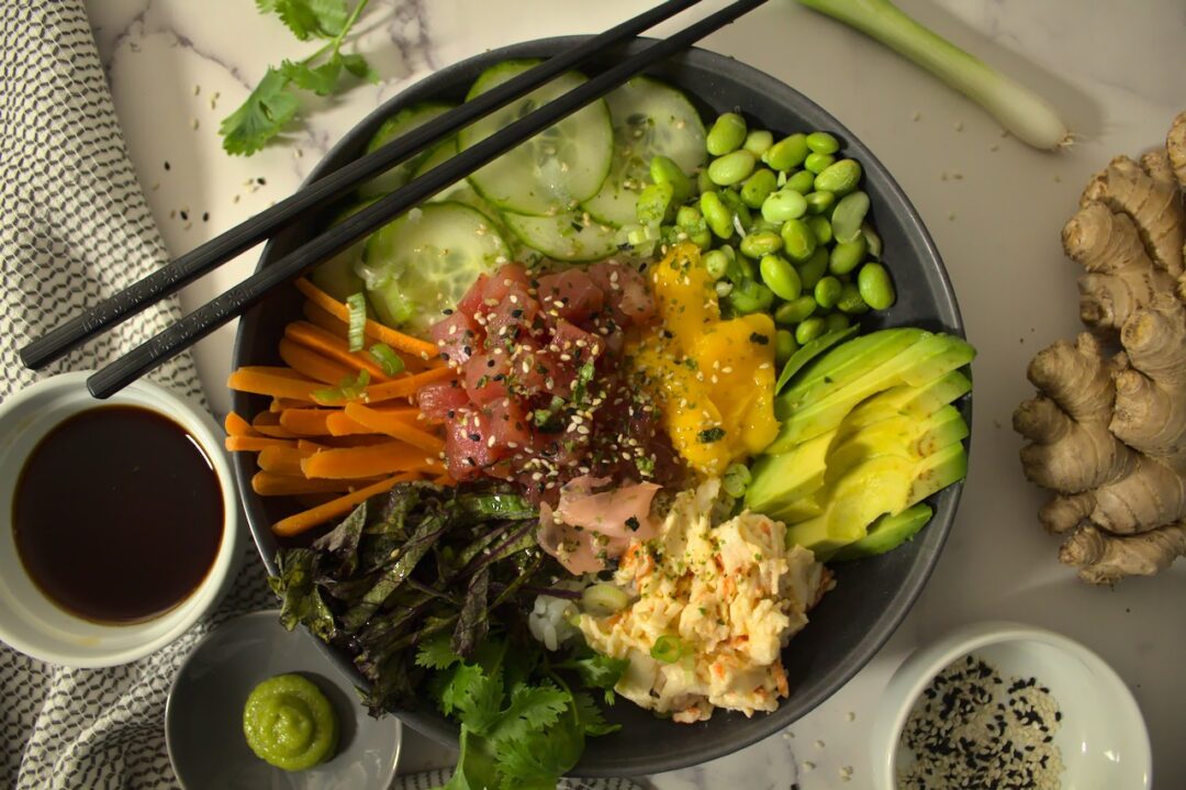 Overhead shot of plated poke bowl with tuna and imitation crab