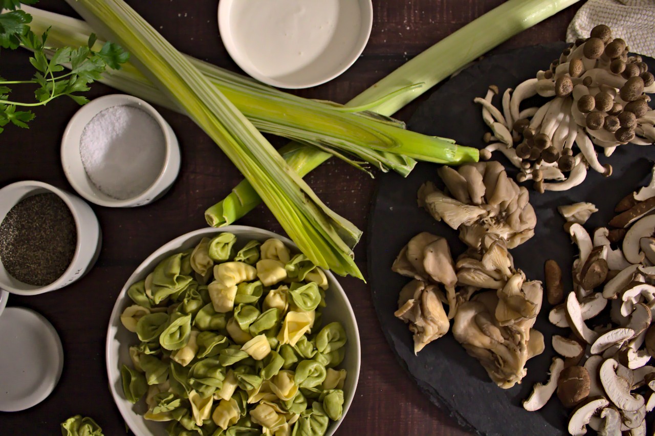 Overhead shot of tortellini, leeks, and mushrooms