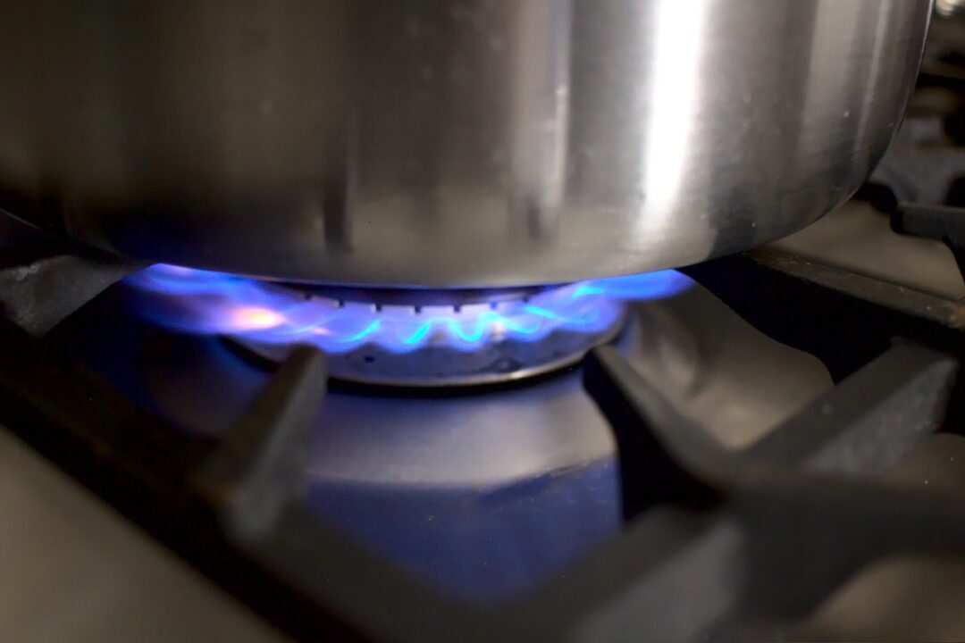 Closeup photo of lit cooktop burner