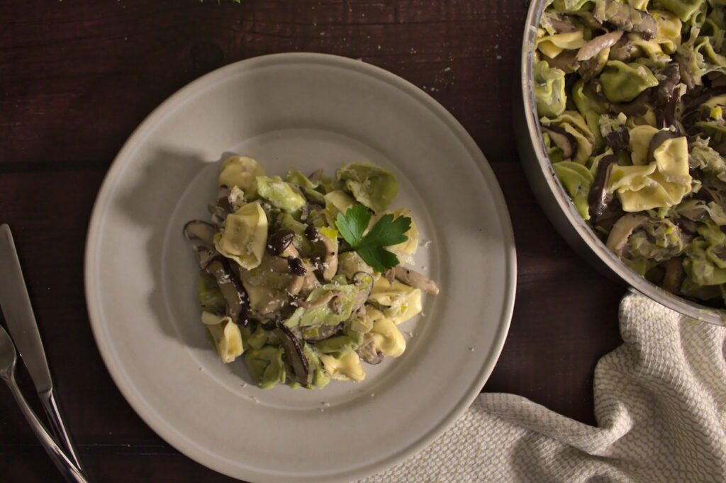 Overhead photo of plated mushroom leek tortellini pasta