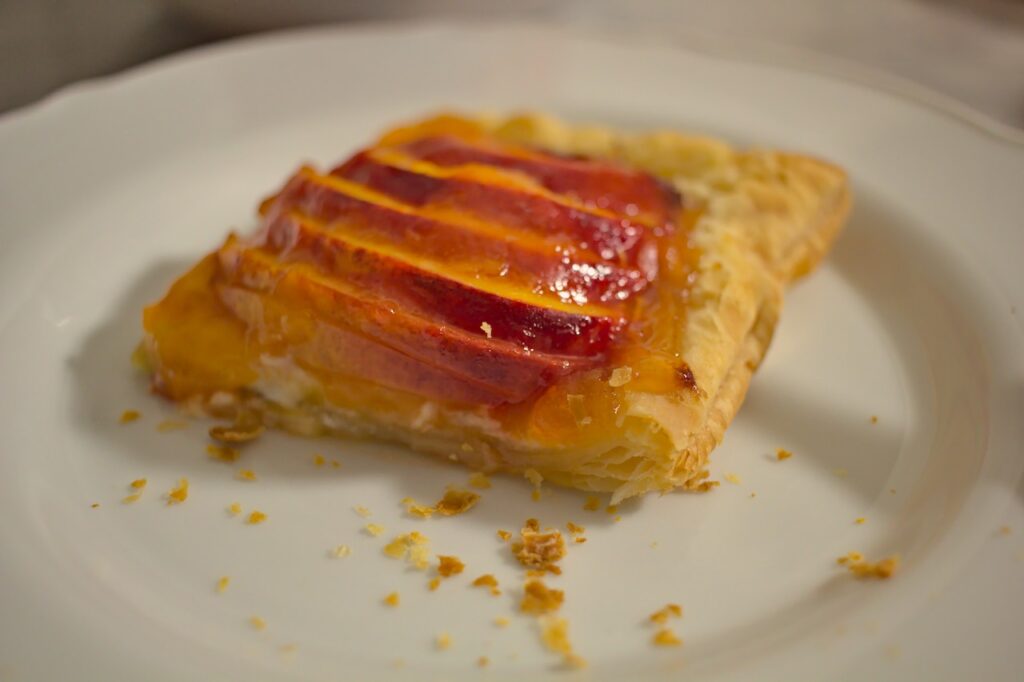 Plated slice of nectarine and goat cheese tart