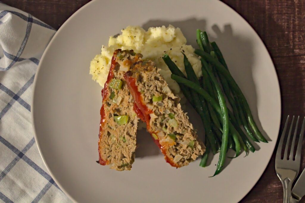 Overhead photo of plated meatloaf, mashed potatoes, and green beans