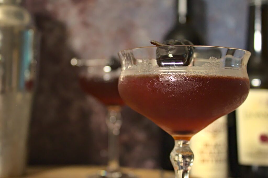 Closeup photo of Michigan tart cherry Manhattan in a coupe glass