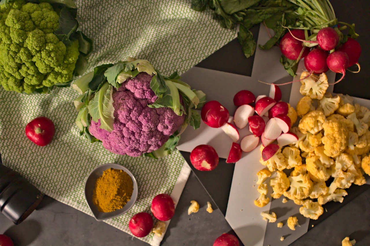 Overhead photo of rainbow cauliflower and radishes