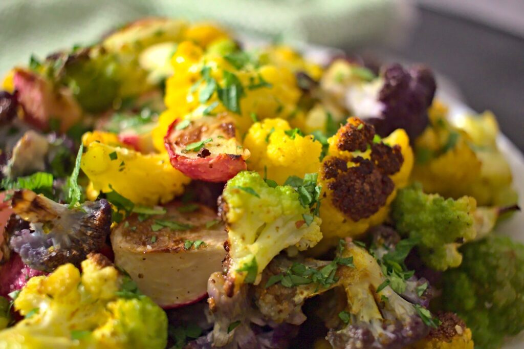 Closeup photo of roasted rainbow cauliflower and radishes