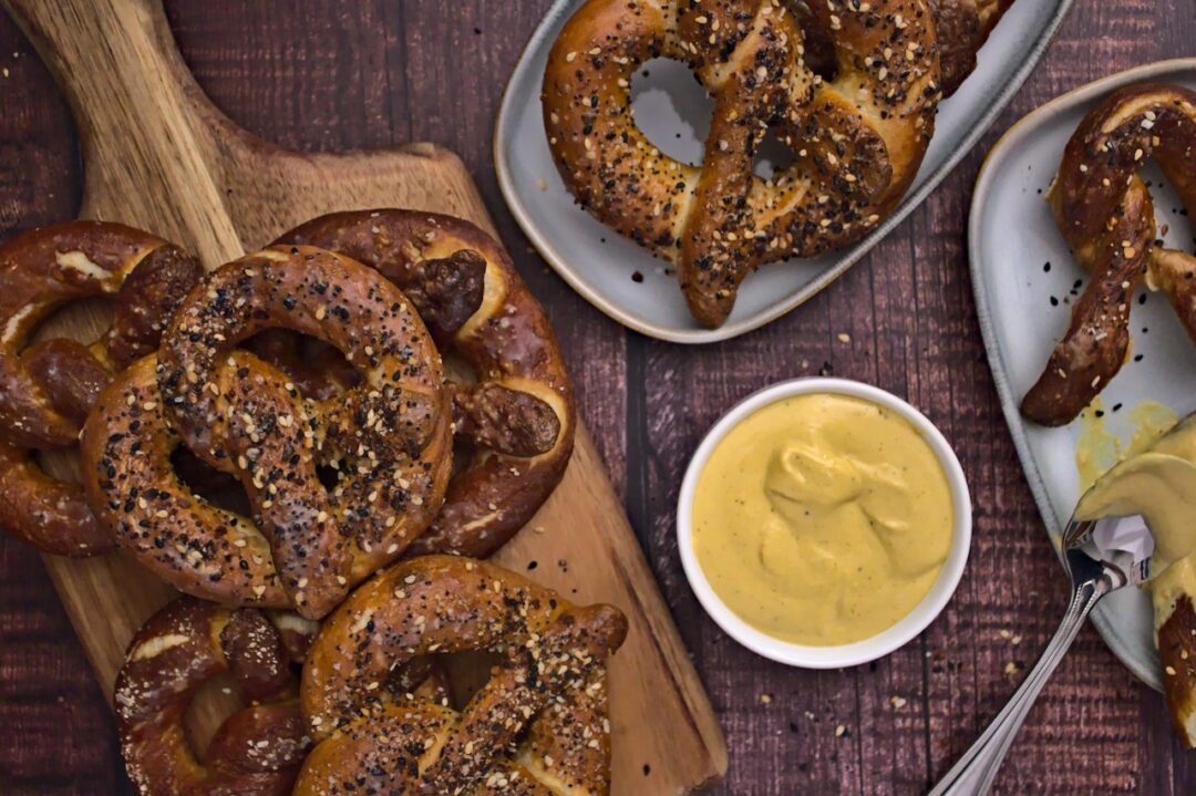 Overhead photo of baked soft pretzels with beer cheese dipping sauce