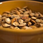 Closeup photo of roasted pumpkin seeds in a bowl