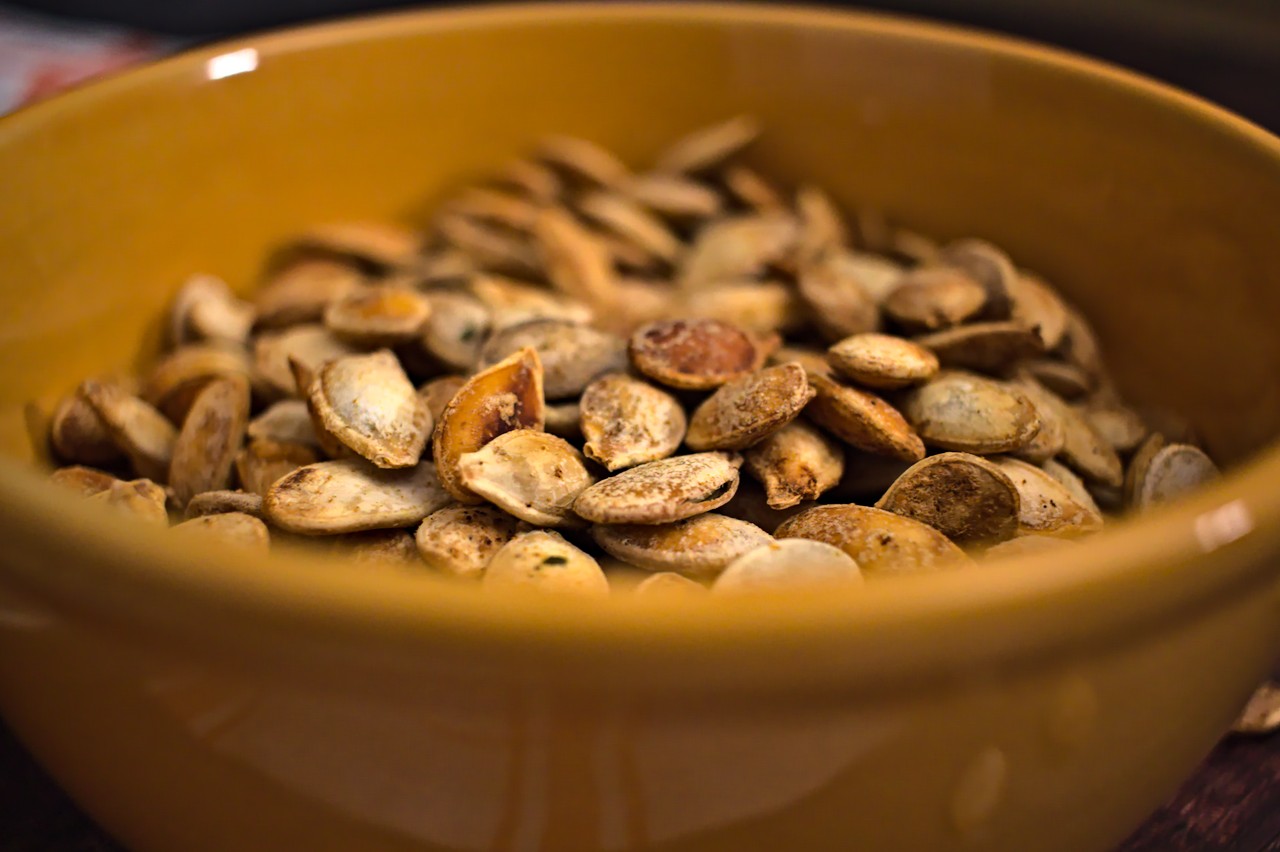 Closeup photo of roasted pumpkin seeds in a bowl