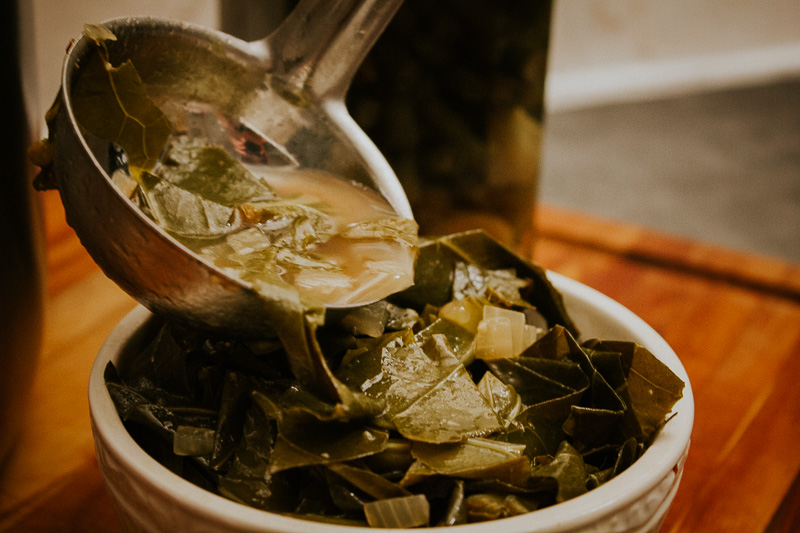 photo of ladle pouring collard greens into a bowl